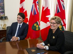 Canada's Prime Minister designate Justin Trudeau (L) meets with Ontario Premier Kathleen Wynne at Queen's Park in Toronto, October 27, 2015. REUTERS/Mark Blinch