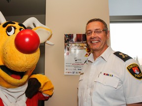 Operation Red Nose mascot Rudy, left, poses for a photo with Kingston Police Chief Gilles Larochelle. (Julia McKay/The Whig-Standard)