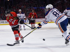 Oilers defenceman Brandon Davidson tries to block a shot by Blackhawks forward Artemi Panarin during their Nov. 8 game in Chicago. (USA TODAY SPORTS)