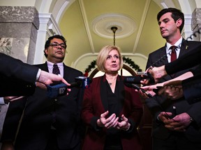 Alberta Premier Rachel Notley, centre, is flanked by Calgary mayor Naheed Nenshi, left, and Edmonton mayor Don Iveson, right, after a meeting between the Premier and the mayor's outside the Premier's office at the Alberta Legislature Building in Edmonton, Alta., on Wednesday, Nov. 18, 2015. Codie McLachlan/Edmonton Sun/Postmedia Network