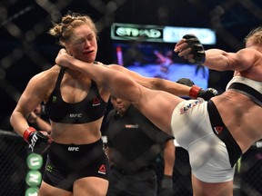 Holly Holm of the US lands a kick to the neck to knock out compatriot Ronda Rousey and win the UFC title fight in Melbourne on November 15, 2015. (AFP PHOTO/Paul CROCK)