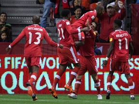 Canada's Atiba Hutchinson, from left, Cyle Larin, Julian de Guzman, Will Johnson and Tosaint Ricketts celebrate Johnson's goal against Honduras during first half CONCACAF 2018 World Cup qualifying soccer action in Vancouver, B.C., on Friday November 13, 2015. (THE CANADIAN PRESS/Darryl Dyck)