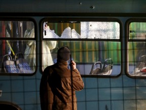 Forensic personnel investigate a bus with windows broken by bullets after an attack in Sarajevo, November 19, 2015. Two soldiers of the Bosnian army were shot dead late on Wednesday when an attacker opened a fire from an automatic weapon at a betting shop near the army barracks at the periphery of the capital Sarajevo. REUTERS/Dado Ruvic
