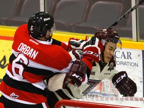 Peterborough Petes' Jonathan Ang is highsticked by Ottawa 67s' Ryan Orban during first period OHL action on Wednesday November 18, 2015 at the Memorial Centre in Peterborough, Ont. Clifford Skarstedt/Peterborough Examiner/Postmedia Network