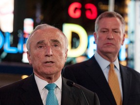 New York City Police Commissioner William Bratton (C) and New York City Mayor Bill de Blasio (R) deliver remarks at a news conference in Times Square in the Manhattan borough in New York, November 18, 2015. REUTERS/Stephanie Keith