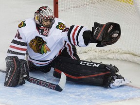 Corey Crawford reaches across his net to catch a shot by Taylor Hall that appeared to be going in. (David Bloom, Edmonton Sun)