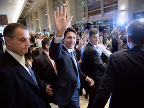 Canada's Prime Minister Justin Trudeau (C) waves to members of the media and summit volunteers as he leaves after a press conference at the Asia-Pacific Economic Cooperation (APEC) Summit in Manila on November 19, 2015. Asia Pacific leaders called on November 19 for more global cooperation in the struggle against terrorism, as a wave of deadly attacks claimed by the Islamic State group dominated the final day of the regional trade summit.    AFP PHOTO / TED ALJIBE