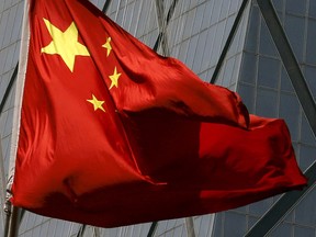 China's national flag is seen in a commercial district in Beijing in this April 20,  2015 file photo.     REUTERS/Kim Kyung-Hoon/Files