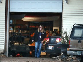 A police car is driven into a garage, Wednesday, Nov. 18, 2015, in Herman, Minn., near where authorities located two teenage sisters from Lakeville who have been missing for more than two years. The girls, Gianna and Samantha Rucki, now 16 and 17 years old respectively, hadn't been seen in public since April 2013 after disappearing in a custody dispute, were found at a horse farm in western Minnesota after police executed a search warrant, Lakeville police Lt. Jason Polinski told the Star Tribune. (Jerry Holt/Star Tribune via AP)