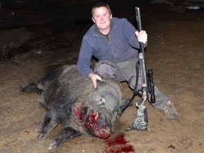 Thomas Blair with the wild boar he shot on his property in Moose Creek, Ont. on Monday, Nov. 16, 2015. Blair says the feral hog weighed in at 460 lbs. Reports of wild boars around Ottawa have been around since 2013. SUBMITTED IMAGE
