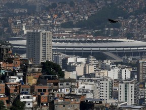 The Maracana stadium is seen between Turano slum (L) and Mangueira slum, in Rio de Janeiro, Brazil, November 19, 2015. Last week's Paris killings have raised fears about the 2016 Olympic Games in Brazil, a country with so little history of terrorism that the president has played down the chance of an attack and legislators long resisted bills to make it a crime.  REUTERS/Sergio Moraes