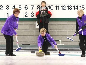 Alison Taylor throws her stone as teammates Elizabeth Shaw and Fiona Macfarlane get set to sweep. The team hails from the Dumfries Curling Club. Gino Donato/Sudbury Star/Postmedia Network