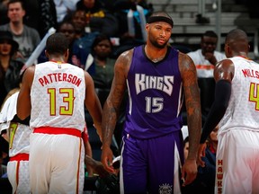 DeMarcus Cousins #15 of the Sacramento Kings reacts after being charged with a foul against Tiago Splitter #11 of the Atlanta Hawks at Philips Arena on November 18, 2015 in Atlanta, Georgia. Kevin C. Cox/Getty Images/AFP
