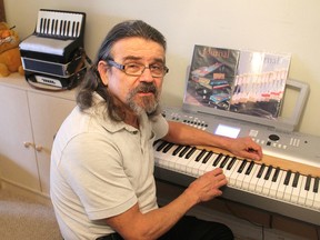 Paul Koktan, at his home in Kingston, has donated a new piano to the H'art Centre, which teaches people with intellectual disabilities by using the arts. (Michael Lea/The Whig-Standard)