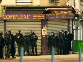 French special police forces secure the area as shots are exchanged in Saint-Denis, France, near Paris, November 18, 2015 during an operation to catch fugitives from Friday night's deadly attacks in the French capital.  REUTERS/Christian Hartmann