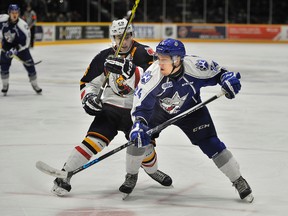 Sudbury Wolves defenceman Cole Mayo goes up against Barrie Colts centre Andrew Mangiapane during first period OHL action at the Barrie Molson Centre on Thursday night.