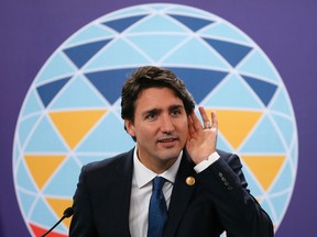 Canadian Prime Minister Justin Trudeau listens to a question during a news conference following the Asia-Pacific Economic Cooperation Summit of Leaders Thursday, Nov. 19, 2015 in Manila, Philippines. According to CP, the cost of the Liberal government's plan to resettle 25,000 Syrian refugees has been pegged at $1.2 billion over six years. (AP Photo/Bullit Marquez)