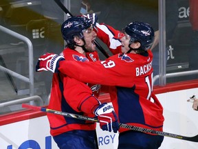 Washington Capitals left wing Alex Ovechkin celebrates his goal with center Nicklas Backstrom during the third period of an NHL hockey game against the Dallas Stars, Thursday, Nov. 19, 2015, in Washington. Ovechkin scored his 484th career NHL goal, breaking Sergei Fedorov's record for most by a Russian-born player. The Stars won 3-2. (AP Photo/Alex Brandon)