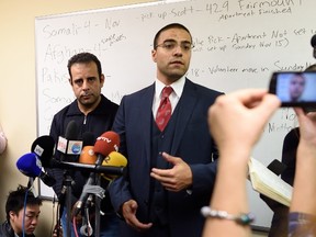 Mahmoud Mahmoud (R), Church World Service and NJ Refugee Resettlement Center director, and Syrian refugee Hussam al Roustom, speak at a news conference on in Jersey City, New Jersey on November 19, 2015. The U.S. House of Representatives voted to ban Syrian and Iraqi refugees from entering the United States until tougher screening measures are in place, a move some slammed as giving in to xenophobia after the Paris attacks. AFP PHOTO/ DON EMMERT