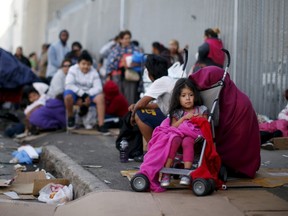 People wait in line at the Fred Jordan Mission annual back to school giveaway of shoes, clothing and backpacks for more than 4,000 homeless and underprivileged children in Los Angeles, California, United States, in this October 1, 2015, file photo. More than 500,000 people - a quarter of them children - were counted as homeless in the United States this year, down slightly from 2014, amid scarce affordable housing that has confounded much of the nation, a study released on November 19, 2015, found. REUTERS/Lucy Nicholson/Files