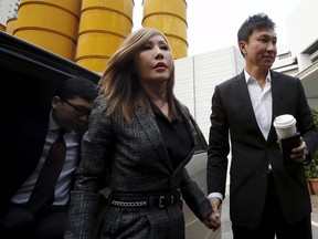 City Harvest Church founder Kong Hee, right, and his wife Sun Ho, also known as Ho Yeow Sun, arrive at the State Courts in Singapore October 21, 2015. (REUTERS/Edgar Su)
