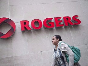 A pedestrian walks past the Rogers Building, in Toronto, on April 22, 2014. Rogers Media has agreed to pay a $200,000 fine, levied under anti-spam legislation, to the CRTC for allegedly sending unsolicited email advertisements. THE CANADIAN PRESS/Darren Calabrese