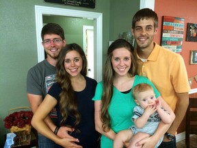 This image released by TLC shows, from left, Ben Seewald, Jessa Seewald, Jill Dillard, holding her baby Israel Dillard and Derik Dillard. (TLC via AP)