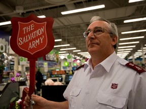 Terry Cook stands beside a kettle stand in preparation for the Salvation Army's Christmas Kettle campaign at the Save On Foods in Spruce Grove on Thursday, Nov. 12. Cook is the Major for the St. Albert Salvation Army and he hopes to raise $300,000 this year - Yasmin Mayne