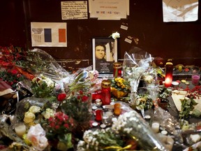 A picture of a victim is seen in front of Le Carillon restaurant a week after a series of deadly attacks in Paris. (REUTERS/Benoit Tessier)
