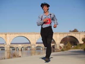 In this photo taken on Sunday, Nov. 8, 2015, Leroy Stolzfus, of Gordonville runs in the 2015 Harrisburg Marathon in Harrisburg, Pa. The Pennsylvania man turned heads as he whizzed by fellow runners at the Harrisburg Marathon, not because of his speed, but because of his unusual racing attire. Stolzfus finished the 26.2-mile race in just over three hours and five minutes — all while wearing his community's traditional clothing.  (Daniel Zampogna /PennLive.com via AP)