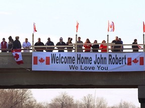 Supporters hang a banner over the overpass on Veterans Memorial Parkway crossing over Highway 401 waiting for the funeral procession of John Gallagher on Friday November 20, 2105.
CRAIG GLOVER/ THE LONDON FREE PRESS / POSTMEDIA NETWORK