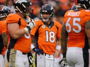 Quarterback Peyton Manning #18 of the Denver Broncos looks on from the huddle against the Kansas City Chiefs at Sports Authority Field at Mile High on November 15, 2015 in Denver, Colorado. The Chiefs defeated the Broncos 29-13.   Doug Pensinger/Getty Images/AFP