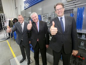 From the left: Dan Guimond, president and CEO, Manitoba Public Insurance, MPI Minister Gord Makintosh and Paul Vogt, president, Red River College. The trio pose before a news conference where a $6 million investment into the automotive repair industry was announced.