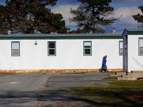 A worker walks past the cadet barracks at CFB Trenton, Ont. Friday, Nov. 20, 2015. Mayors of the municipalities surrounding Canada's largest air base say they're ready to help if needed should Syrian refugees be housed in the barracks. Luke Hendry/Belleville Intelligencer/Postmedia Network
