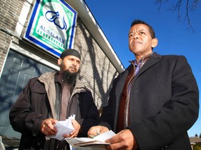 Kawartha Muslim Religious Association president Kenzu Abdella, right, and Imam Shazim Khan reflect after reading letters gathered from an outpouring of support including flowers and coffee were left on steps outside Masjid Al-Salaam on Tuesday on Parkhill Rd. W in Peterborough. The association’s mosque was deliberately set on fire Saturday night. Clifford Skarstedt/Examiner/Postmedia Network