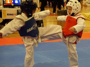 Corina Migulea, five, of the Sarnia Olympic Taekwondo Academy delivers a kick to her opponent at the Toronto Open Taekwondo Championships. With no other girls at her belt rank and age to compete with, Migulea fought in the boy's division and won gold, one of 25 medals earned by the Sarnia club at this event. (Handout)