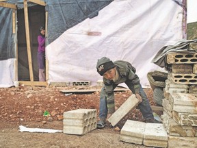 Nine-year-old Adam works 12-hour days doing construction in Bekaa Valley, Lebanon. (Photo source: Romenzi, UNICEF.)