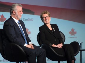 Ontario Premier Kathleen Wynne, right, and Quebec Premier Philippe Couillard share a laugh during a panel discussion in Ottawa, On Friday November 20, 2015. 
THE CANADIAN PRESS/Adrian Wyld