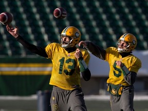 Edmonton Eskimos quarterback Mike Reilly (13), left, and quarterback Jordan Lynch (5) run a drill during practice in Edmonton, Alta., on Friday November 20, 2015. The Eskimos take on the Calgary Stampeders in the West Division final on Sunday. THE CANADIAN PRESS/Jason Franson.