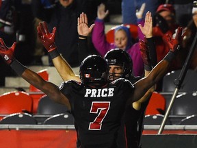 Ottawa Redblacks' Brad Sinopoli celebrates a touchdown with teammate Maurice Price against Montreal Alouettes' during third quarter CFL action in Ottawa on Thursday, Oct 1, 2015. (THE CANADIAN PRESS/Sean Kilpatrick)