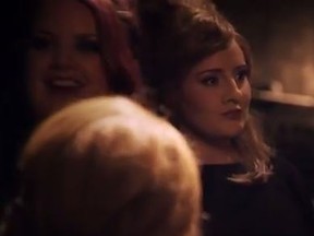 Adele in disguise waits for her turn to sing along with other impersonators. (YouTube/Screengrab)