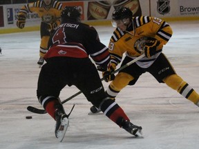 Sarnia Sting forward Sasha Chmelevski tries to deke Owen Sound Attack defenceman Thomas Schemitch during the Ontario Hockey League game at the Sarnia Sports and Entertainment Centre Friday night. Sarnia won 1-0 as goalie Justin Fazio earned his second-straight shutout. (Terry Bridge, Sarnia Observer)