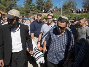 Israelis carry the body of 51-year-old Yaacov Don during his funeral in the Kfar Etzion cemetery, in the Israeli-occupied West Bank. He was shot and killed by a Palestinian assailant who opened fire with on a convoy of cars killing three people near the Gush Etzion settlement block. Don taught at a Hebrew school in Toronto for several years beginning in the late '90s. (AFP PHOTO / MENAHEM KAHANA)