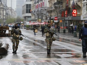 Belgian soldiers and a police officer patrol in central Brussels, on Nov. 21, 2015, after security was tightened in Belgium following the fatal attacks in Paris. Belgium raised the alert status for its capital Brussels to the highest level on Saturday, shutting the metro and warning the public to avoid crowds because of a "serious and imminent" threat of an attack. (REUTERS/Youssef Boudlal)