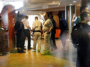 French investigators are seen inside the Radisson Blu hotel in Bamako, Mali, on Nov. 21, 2015. (AP Photo/Jerome Delay)