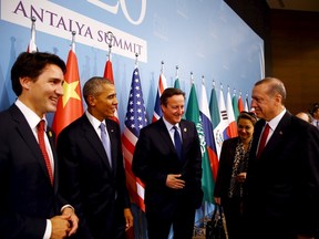 Turkey's President Tayyip Erdogan (R) chats with Canada's Prime Minister Justin Trudeau (L), U.S. President Barack Obama (2nd L) and British Prime Minister David Cameron (3rd L) before a working dinner at the Group of 20 (G20) summit in the Mediterranean resort city of Antalya, Turkey, November 15, 2015. (REUTERS/Kayhan Ozer/Pool)