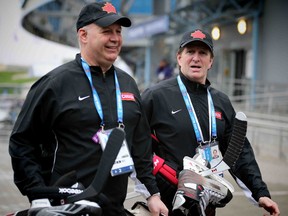 Team Canada coaches Claude Julien and Mike Babcock make their  way to the hockey practice facility at the 2014 Olympic Winter Games in Sochi, Russia, on Tuesday February 18, 2014. Al Charest/Calgary Sun