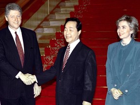A file picture taken on July 10, 1993, shows U.S. President Bill Clinton, accompanied by his wife Hillary, shaking hands with South Korean President Kim Young-Sam at the Blue House in Seoul. Former South Korean President Kim Young-Sam, who became the country's first civilian ruler for more than 30 years, died on Nov. 22, 2015, hospital officials said. He was 87. (AFP PHOTO/CHOO YOUN-KONG)