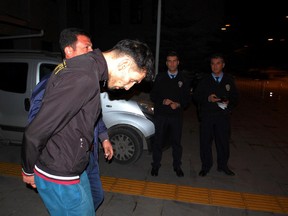 Turkish police detain Ahmad Dahmani, in Antalya, Turkey, late Friday, Nov. 20, 2015. (DHA via AP)