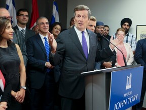 Toronto Mayor John Tory is surrounded by religious leaders after they met on Sept. 10, 2015. to discuss how the city will help refugees fleeing Syria. (Veronica Henri/Toronto Sun)